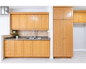 A kitchen with wooden cabinets and a granite countertop.