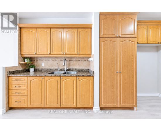 A kitchen with wooden cabinets and a granite countertop.