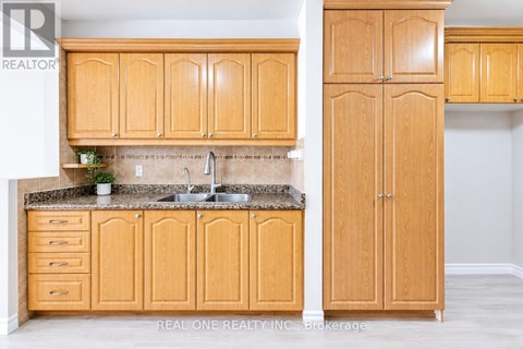 A kitchen with wooden cabinets and a granite countertop.