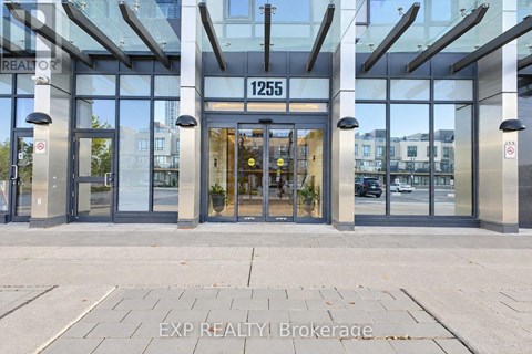 The entrance to a building with glass doors and a sign that reads "1255".