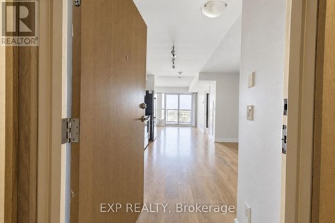 A hallway with wooden doors and a white ceiling.