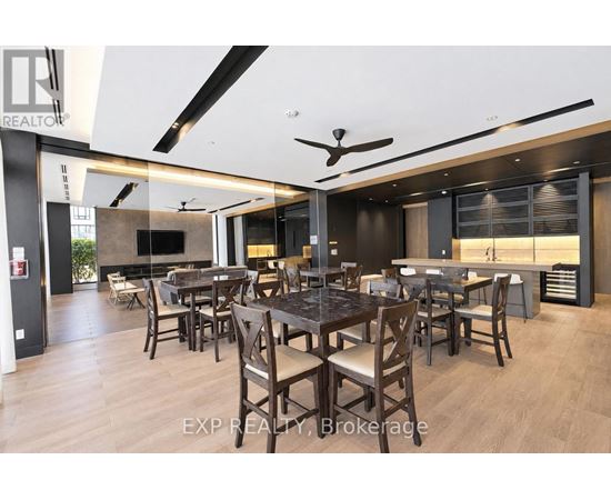 A modern dining room with a dark wood table and chairs.