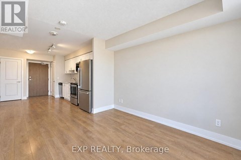 A kitchen area with a refrigerator, microwave, and oven.