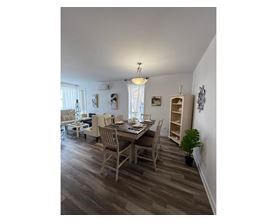 A dining room with a table set for four.