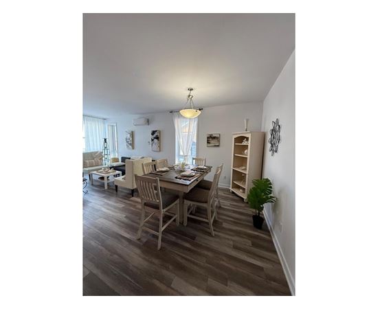 A dining room with a table set for four.