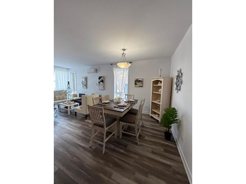 A dining room with a table set for four.