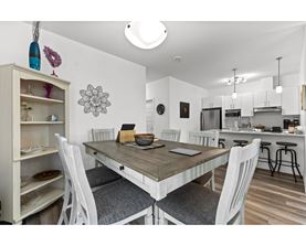 A dining room with a table and chairs.