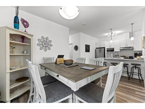 A dining room with a table and chairs.