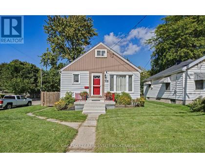 A house with a red door is for sale.