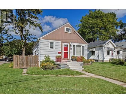 A small house with a red door is for sale.