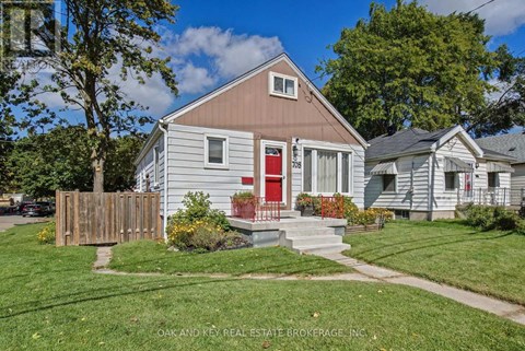 A small house with a red door is for sale.