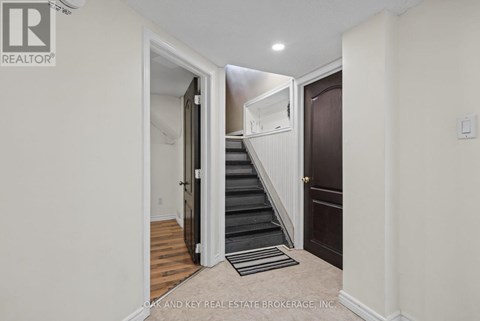 A hallway with a staircase leading to the second floor.