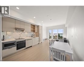 A modern kitchen with a dining table and chairs.