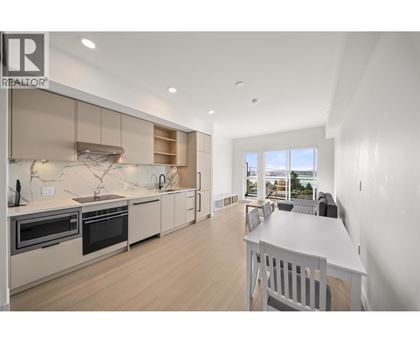 A modern kitchen with a dining table and chairs.