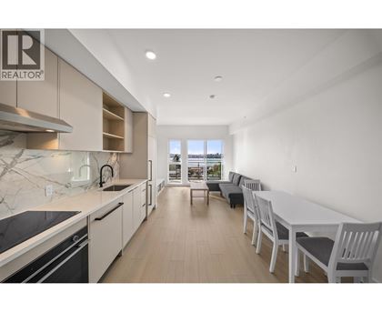 A modern kitchen with a dining area in a real estate listing.