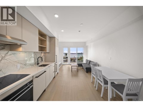 A modern kitchen with a dining area in a real estate listing.