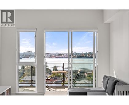 A living room with a view of a bridge and water.