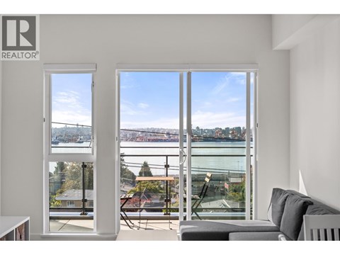 A living room with a view of a bridge and water.