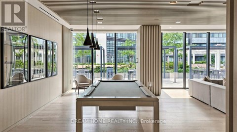 A modern living room with a pool table and a view of the city.