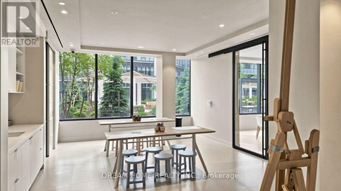 A modern dining room with a table set for four.