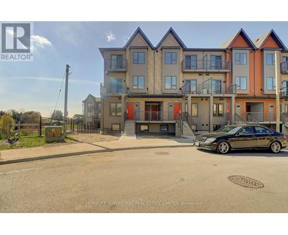 A car is parked in front of a multi-story residential building.