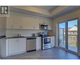 A kitchen with white cabinets and a stainless steel dishwasher.