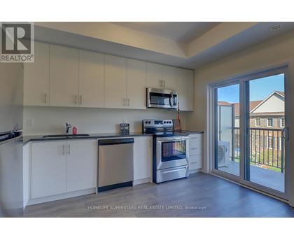 A kitchen with white cabinets and a stainless steel dishwasher.