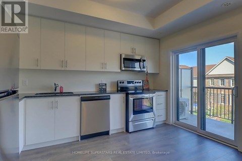 A kitchen with white cabinets and a stainless steel dishwasher.