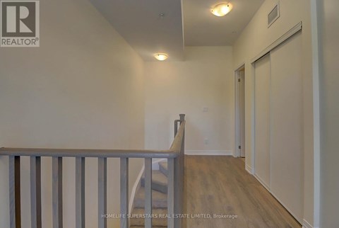 A room with a staircase and a wall with a logo that says REALTOR.
