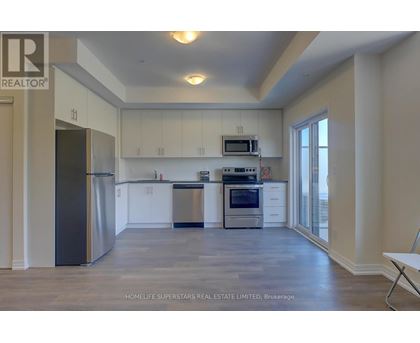 A spacious kitchen with white cabinets and stainless steel appliances.