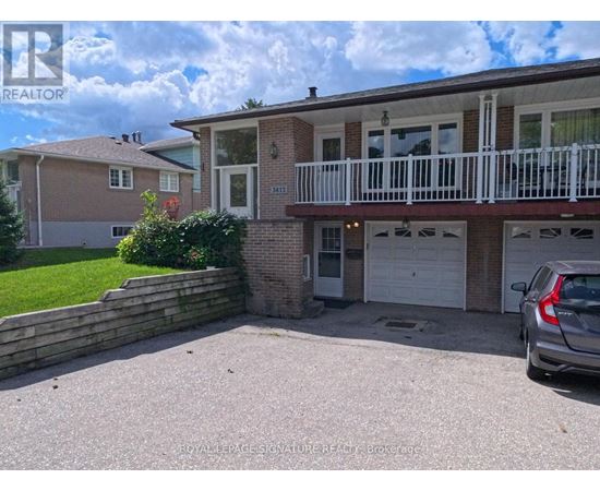 A two-story house with a balcony and a garage.