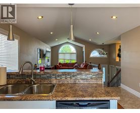 A kitchen with granite countertops and a large island.