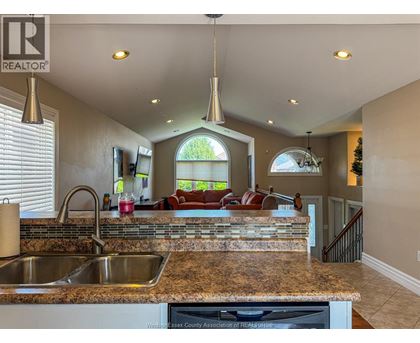 A kitchen with granite countertops and a large island.