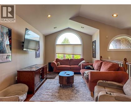 A living room with a brown couch and a television.