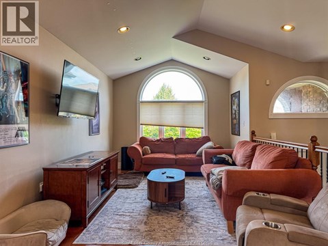 A living room with a brown couch and a television.