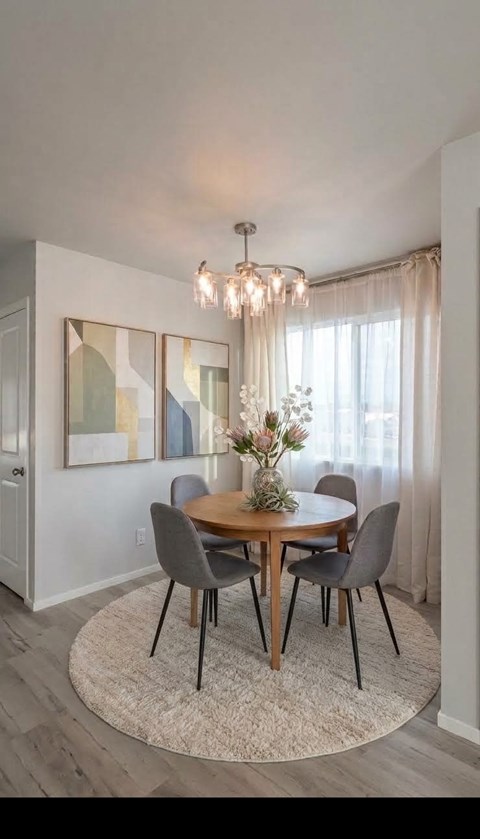 A dining room with a round table and chairs.