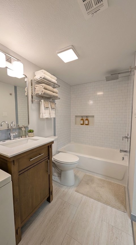 A white bathroom with a white toilet and a white sink.