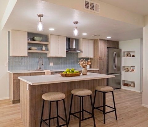 A kitchen with a bar stool and a counter.