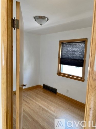 A room with wooden floors and a window with a wooden frame.
