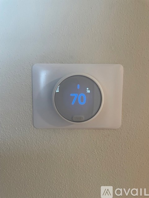 A thermostat shows a temperature of 70 degrees.