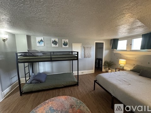 A bedroom with a bunk bed and a single bed.