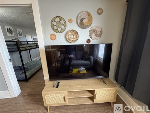 A living room with a television and a bunk bed.