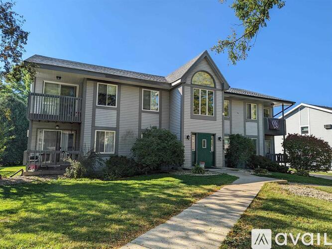 A two-story house with a balcony on the second floor.