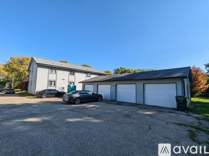 A house with a garage and a car parked in front.