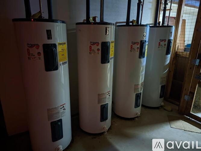 Four water heaters are lined up in a row.