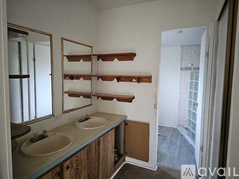 A bathroom with two sinks and a mirrored medicine cabinet.