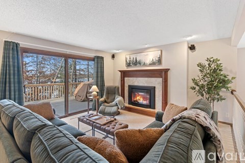 A living room with a fireplace and a couch.