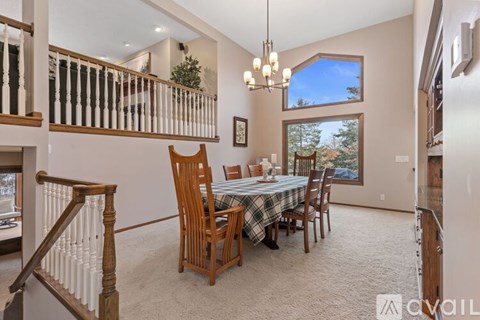 A dining room with a table set for six.