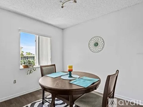 A dining room with a round table and chairs.