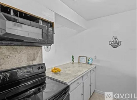 A kitchen with a black oven and a white countertop.